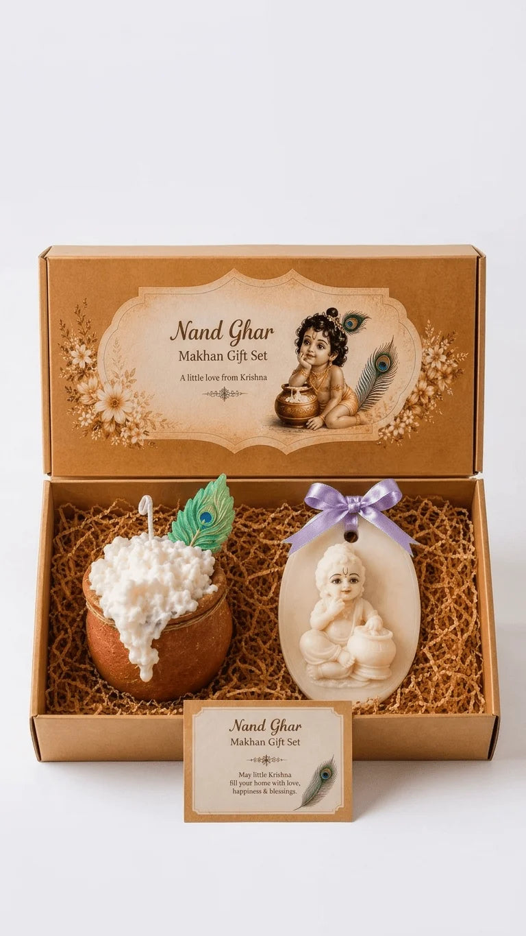 Open brown gift box with a Nand Ghar Makhan Gift Set, featuring a white candle in a pot and a baby Krishna resin hanging.