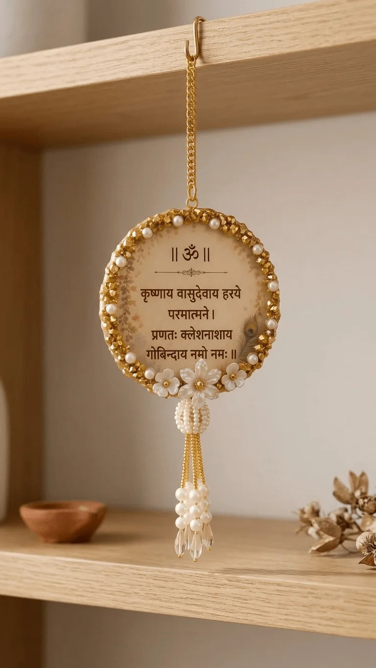 Handcrafted round resin wall hanging with Sanskrit mantra, golden border, pearls, peacock feather, and beaded tassel on a woo