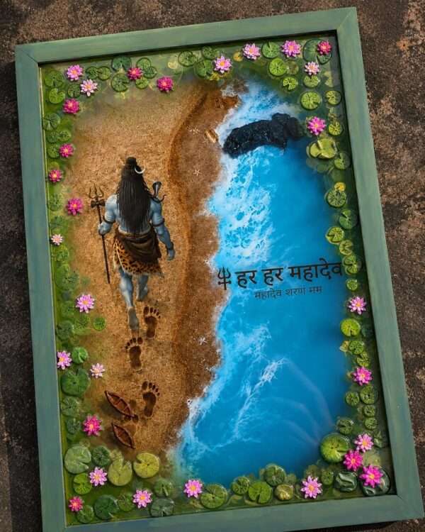 Handcrafted resin art frame depicting Lord Shiva walking on a sandy beach next to a blue ocean, surrounded by pink lotus flow