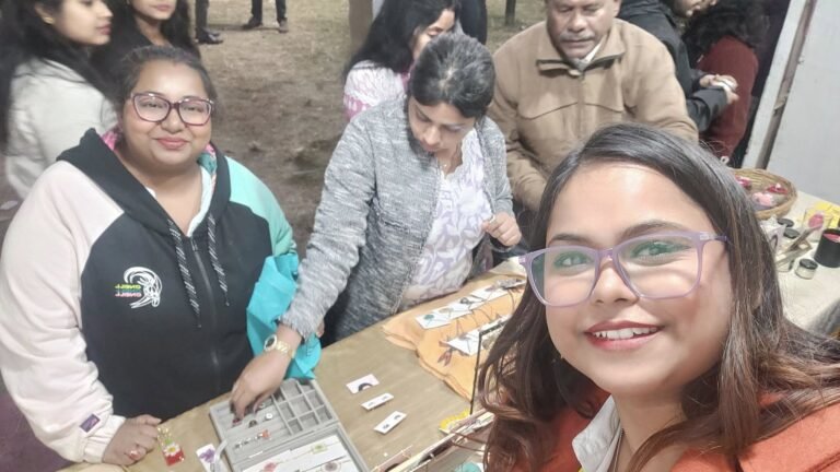 Selfie at a market stall with three women, featuring handmade resin jewelry and keepsakes on display.