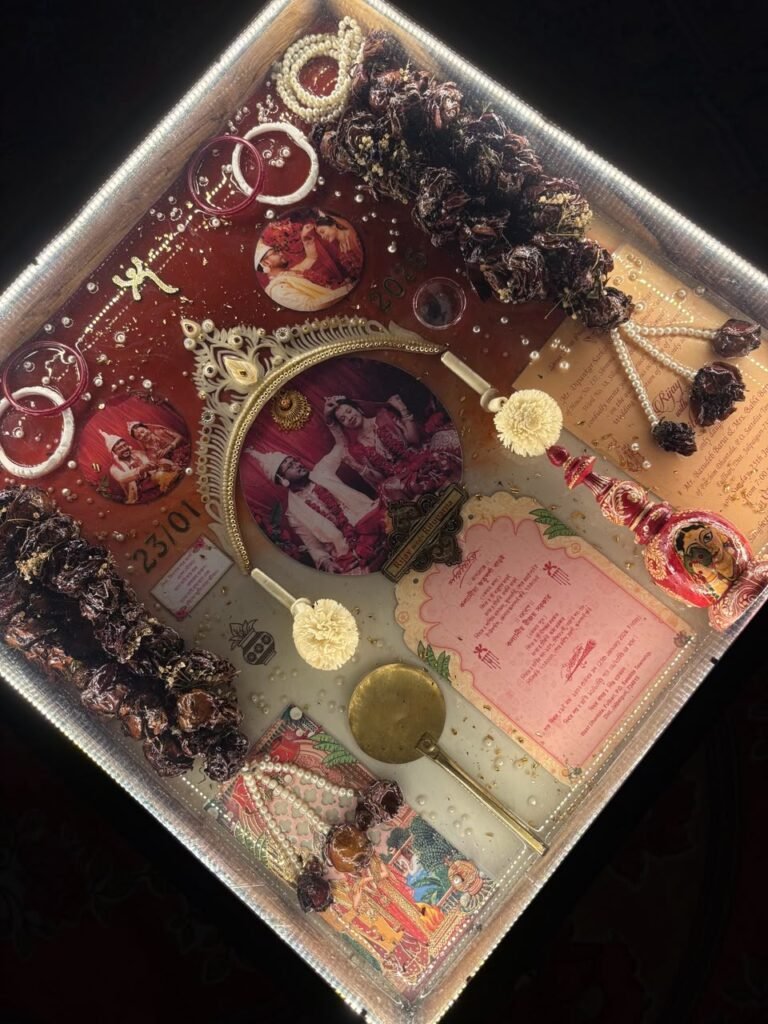 Resin wedding keepsake tray with LED lights, featuring a couple's photos, dried flowers, bangles, and a wedding invitation.