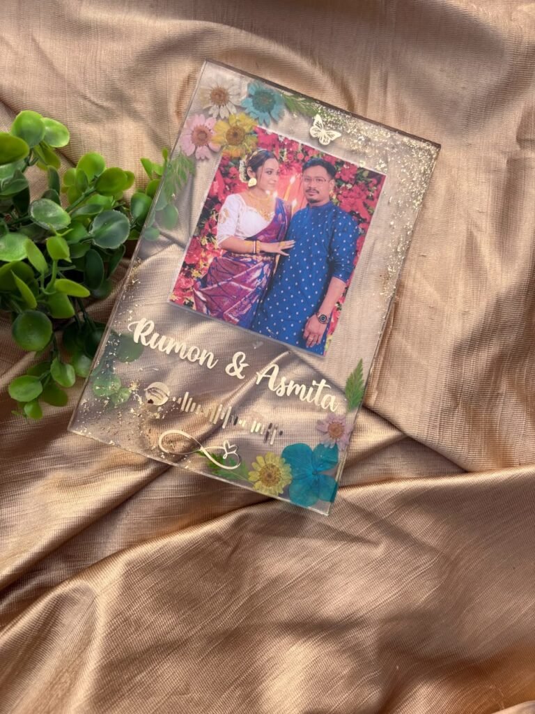 Custom resin photo frame with a couple's picture, names Rumon & Asmita, Spotify code, dried flowers, and gold flakes on golde