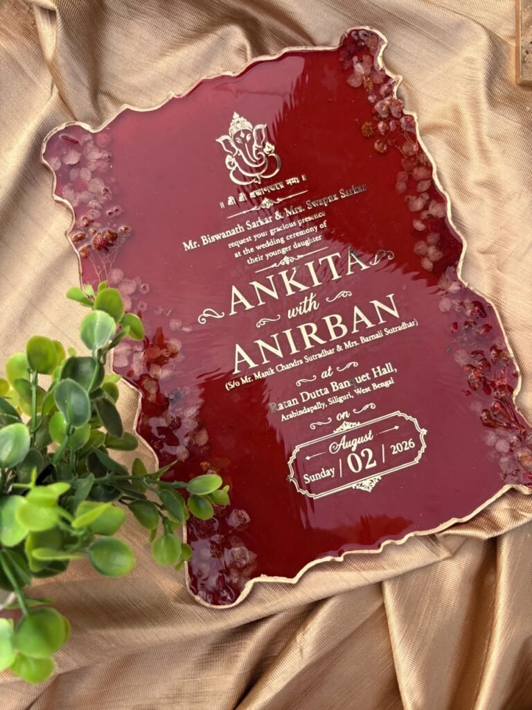 Custom deep red resin wedding keepsake with gold text for Anikta and Anirban, Ganesha, and embedded dried petals on gold fabr